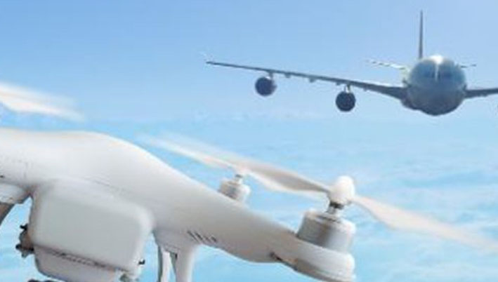 Drone in front of an aeroplane in the sky colour